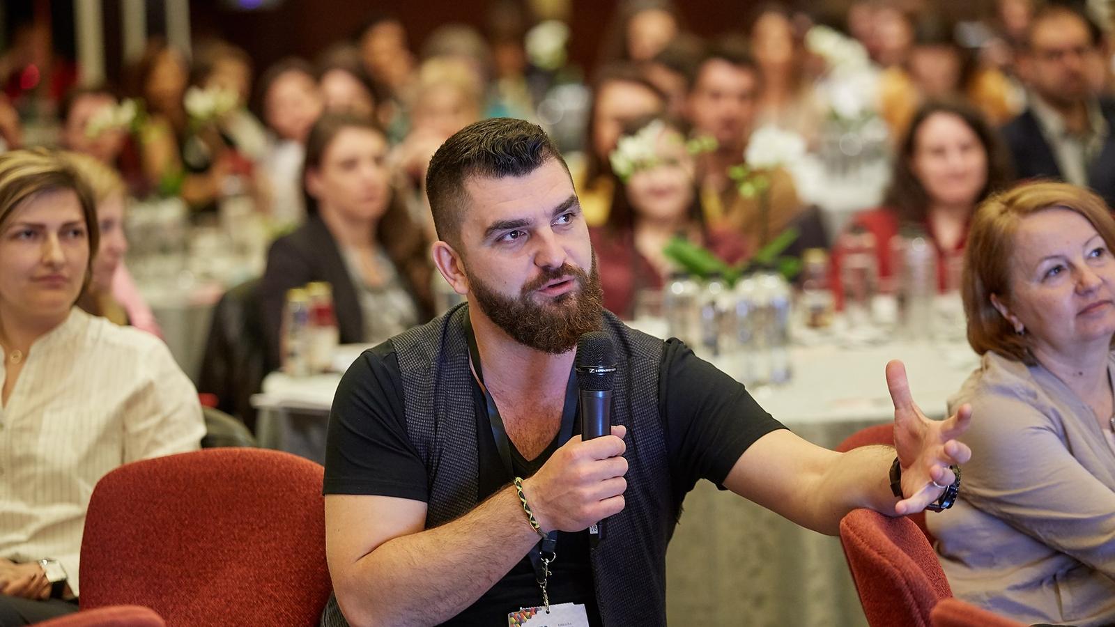 Dragoș Tuță Mihaylov asking a question from the floor at a business conference